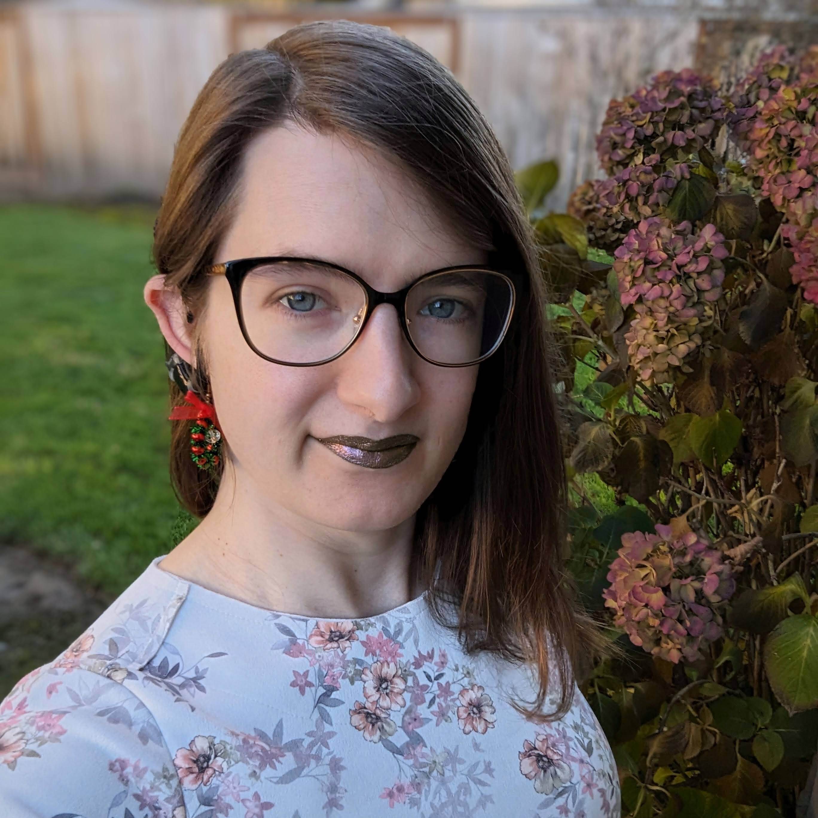 Headshot of Hazel Weakly, smiling weakly